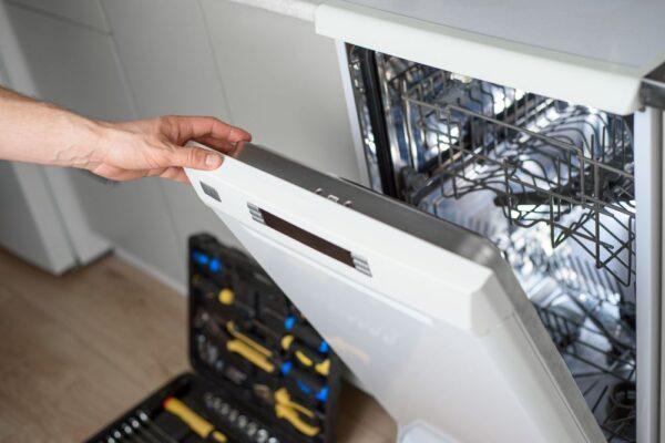 An open dishwasher being inspected by a technician in Indianapolis, showing a repair in progress—representing Unique Repair Services' fast and reliable appliance repair service.