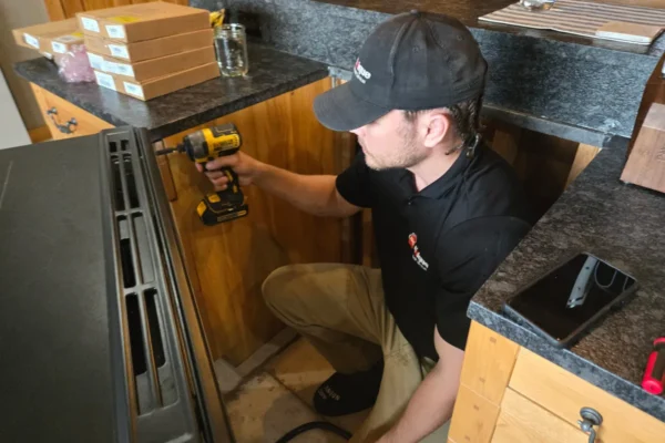 Unique Repair technician installing a range