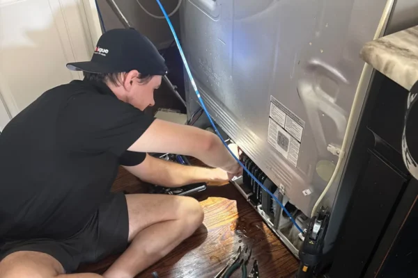 Unique Repair technician replacing a refrigerator compressor