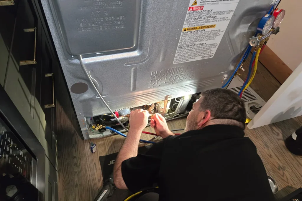Unique Repair technician repairing a refrigerator sealed system